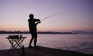 Fishing with the splash from Victoria Falls in the background